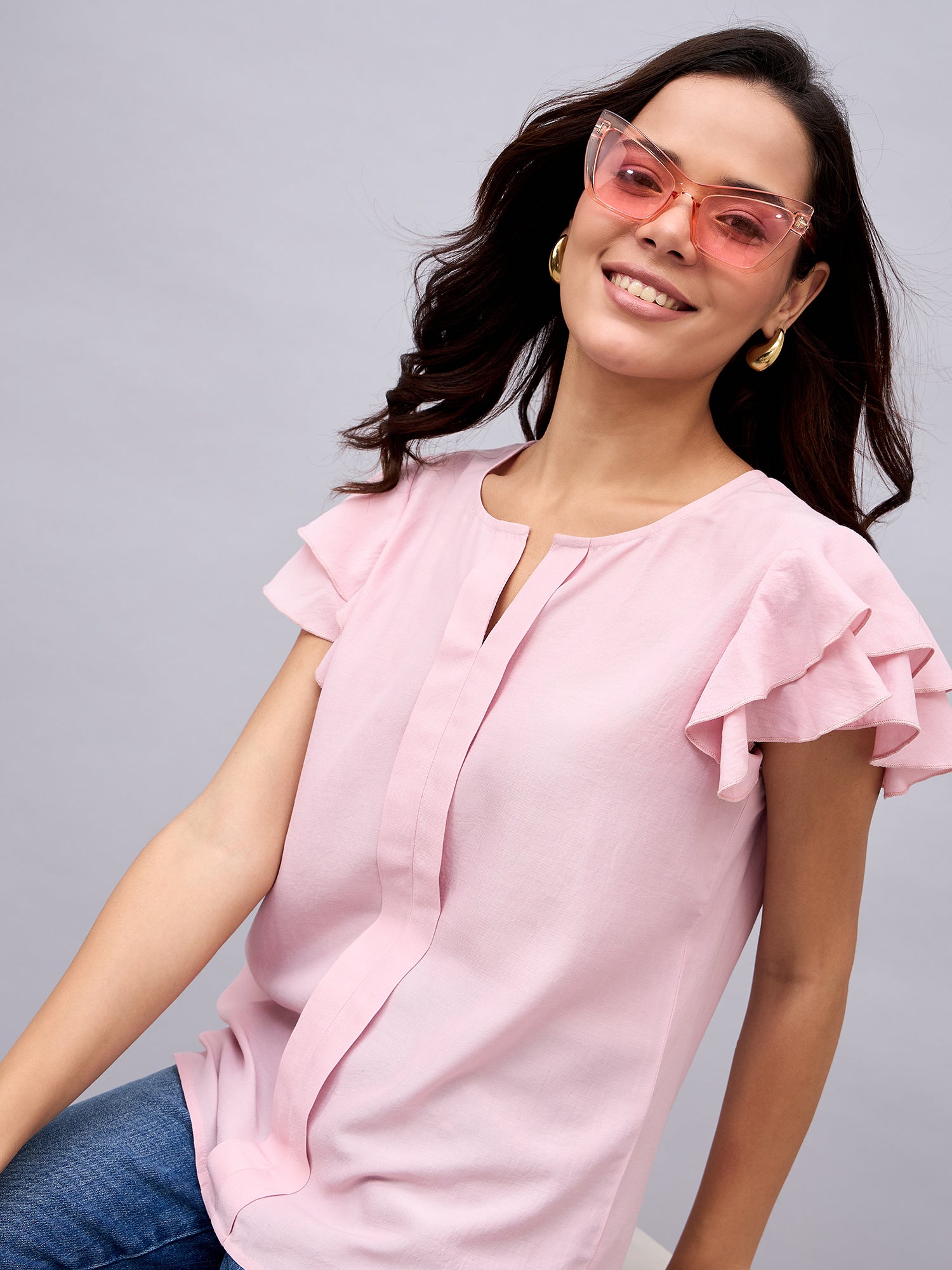 NUWAH pink ruffle top styled with jeans and pink sunglasses – summer look
