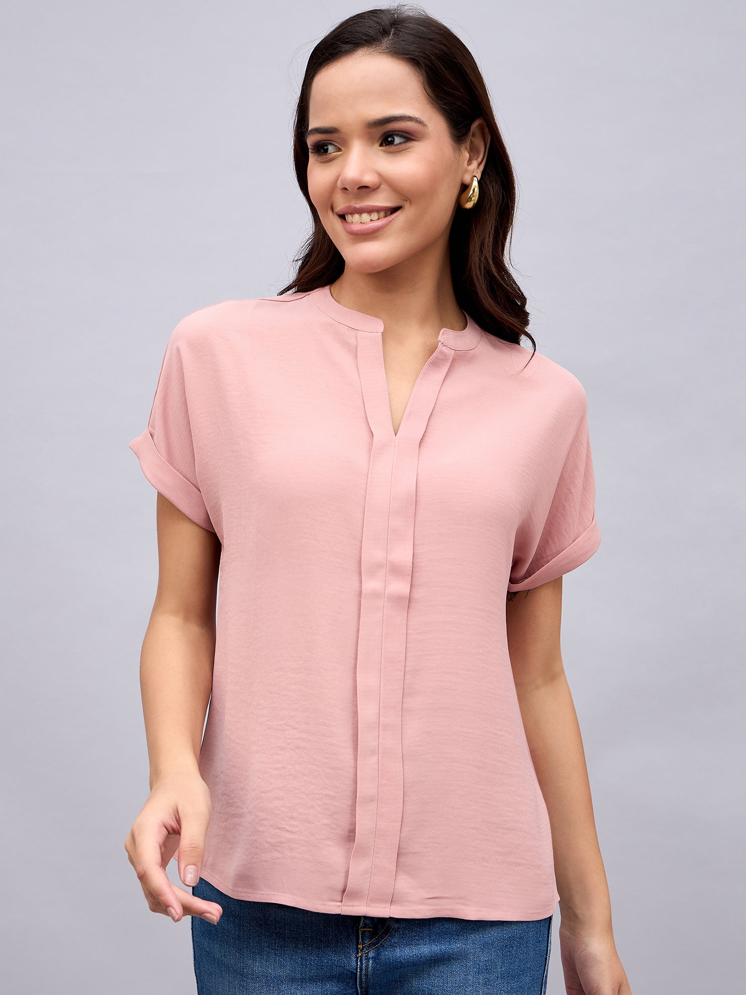 Blush pink top styled with blue jeans and nude bag – NUWAH