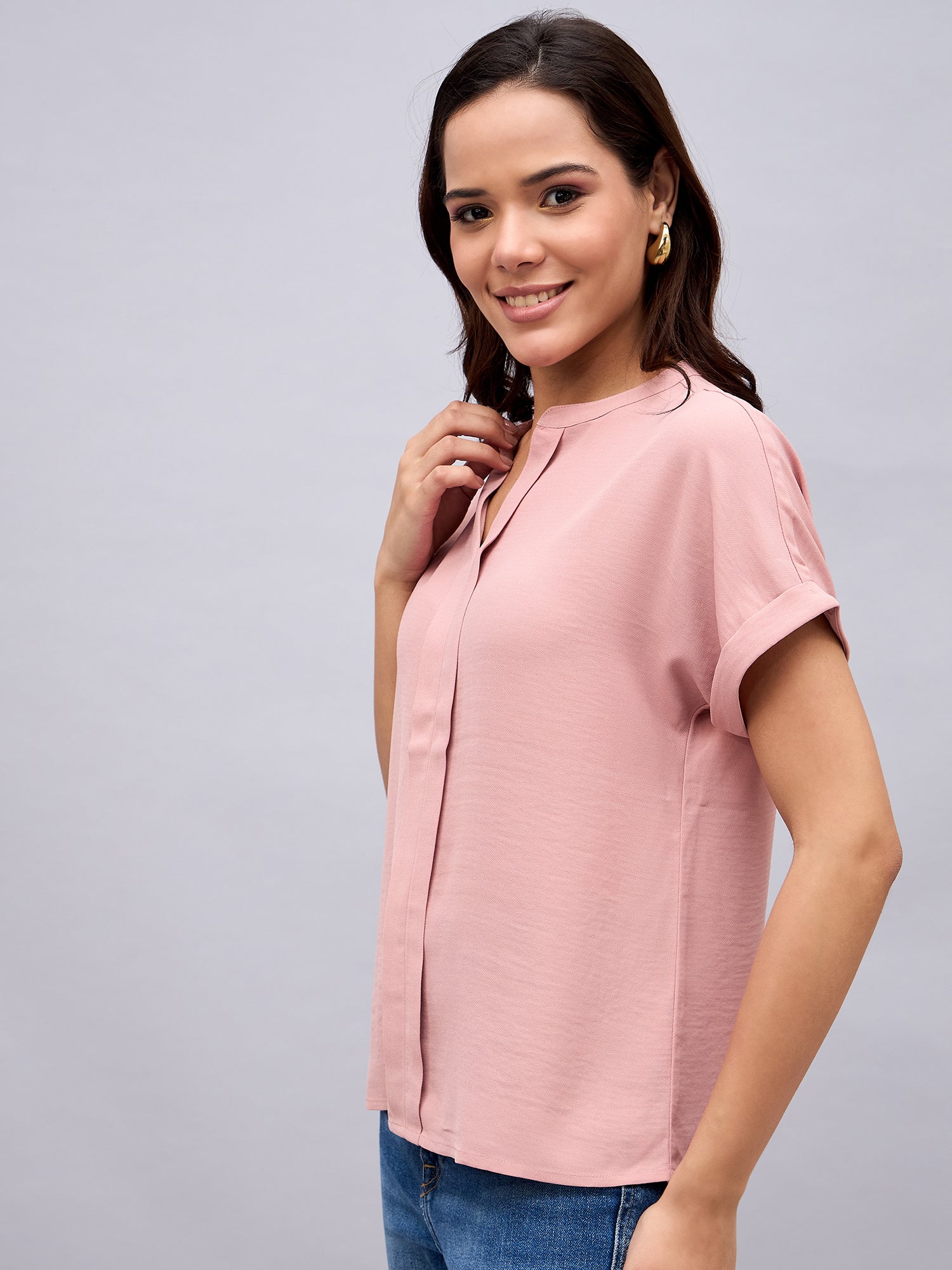 Side profile of NUWAH soft pink mandarin collar top with turned-up sleeves
