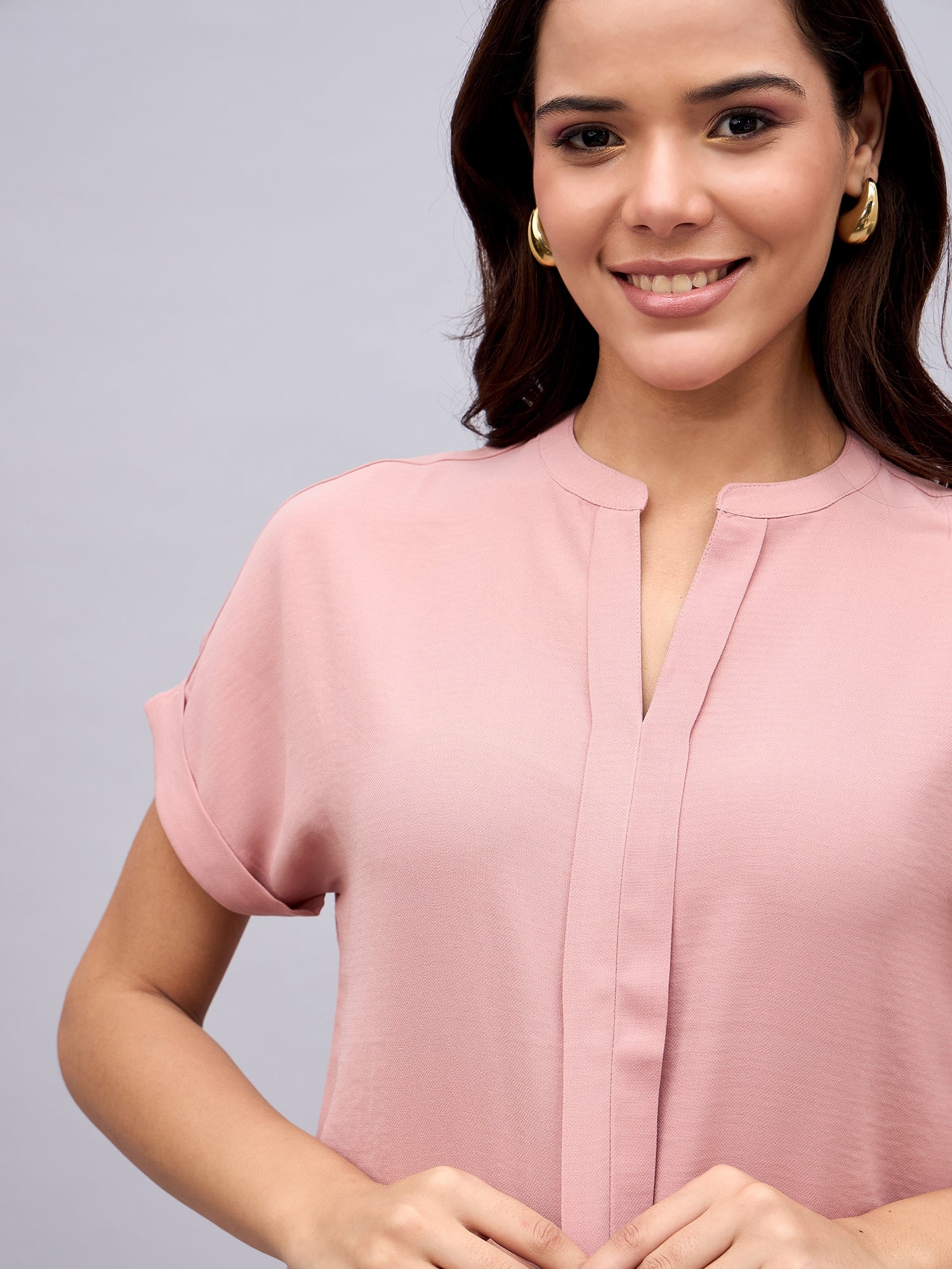 Close-up of mandarin collar and placket on NUWAH textured pink top

